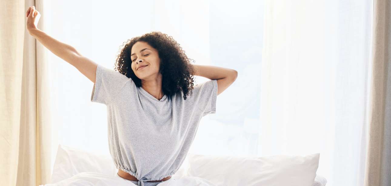 Black woman, morning stretching and waking up in home bedroom after sleeping or resting. Relax, pea